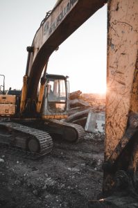 Heavy machinery at a construction site at sunset, showcasing industrial strength and raw power.