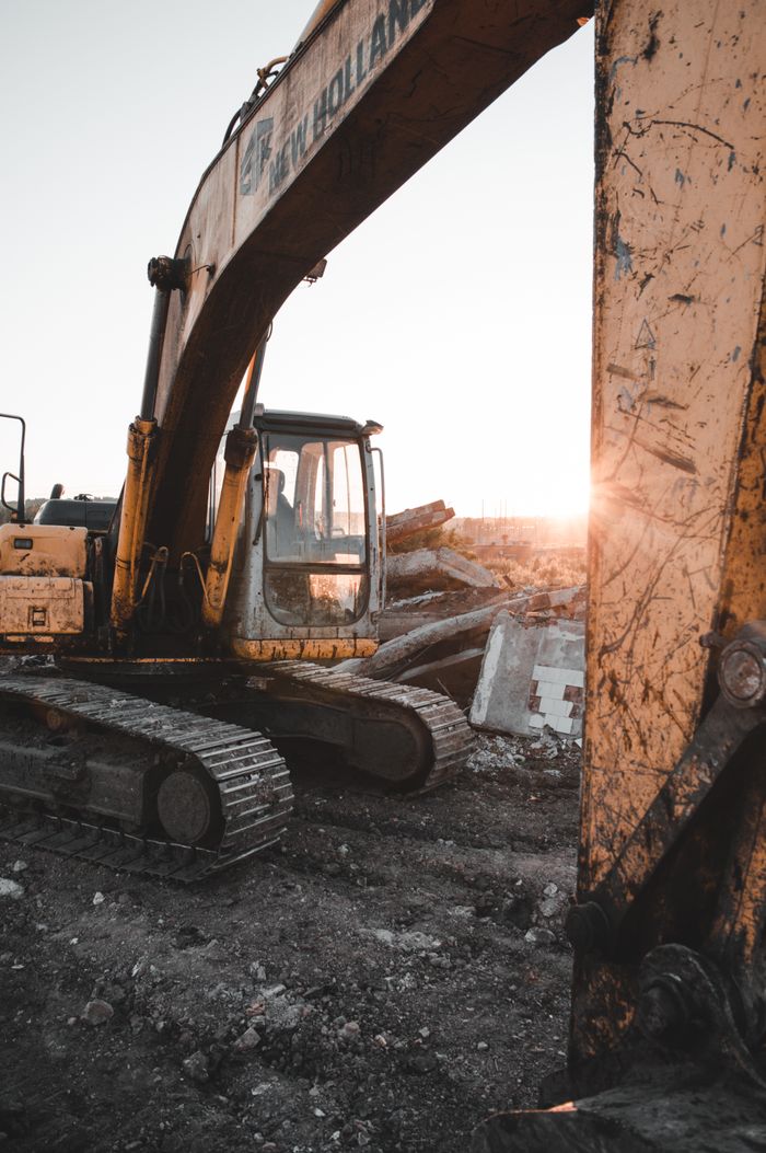 about-img Heavy machinery at a construction site at sunset, showcasing industrial strength and raw power.