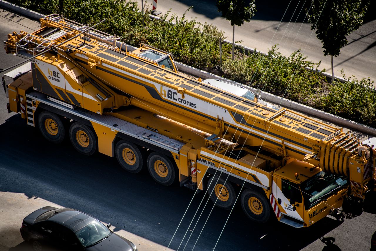 hero-img-02 A mobile crane parked on an urban street in Vilnius, Lithuania.