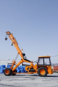 Orange ACE hydraulic crane with extended boom in Faridabad, India