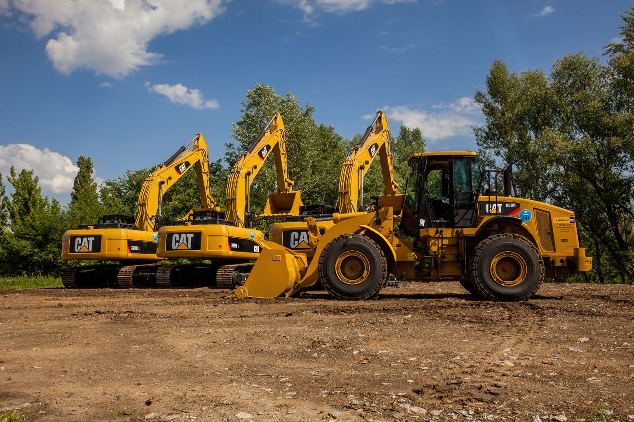 contact-img Four yellow excavators at an outdoor construction site in Kyiv, Ukraine.