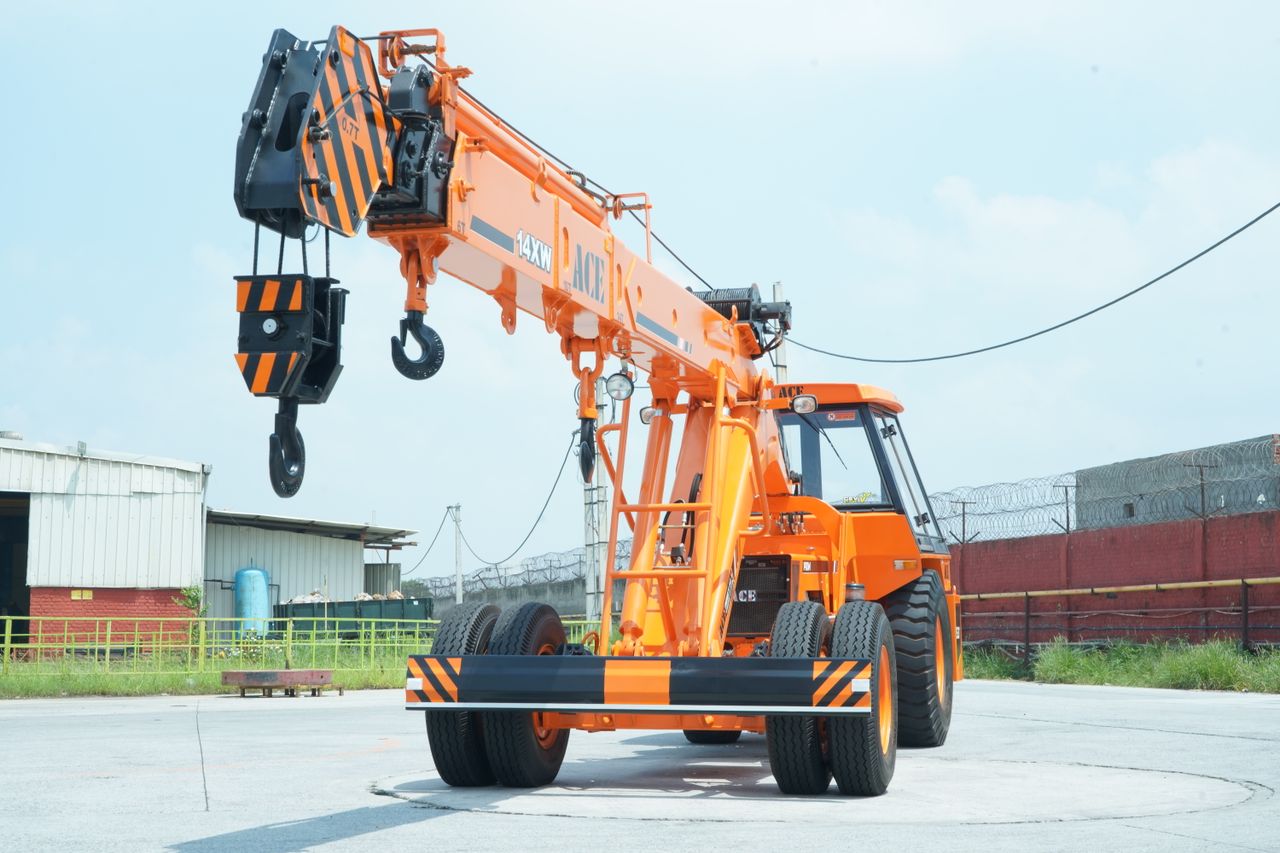 services-02 ACE 14XW orange crane in an industrial yard in Faridabad, India.