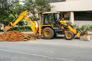 Street view of an excavator in Sandton, highlighting urban development and construction activities.