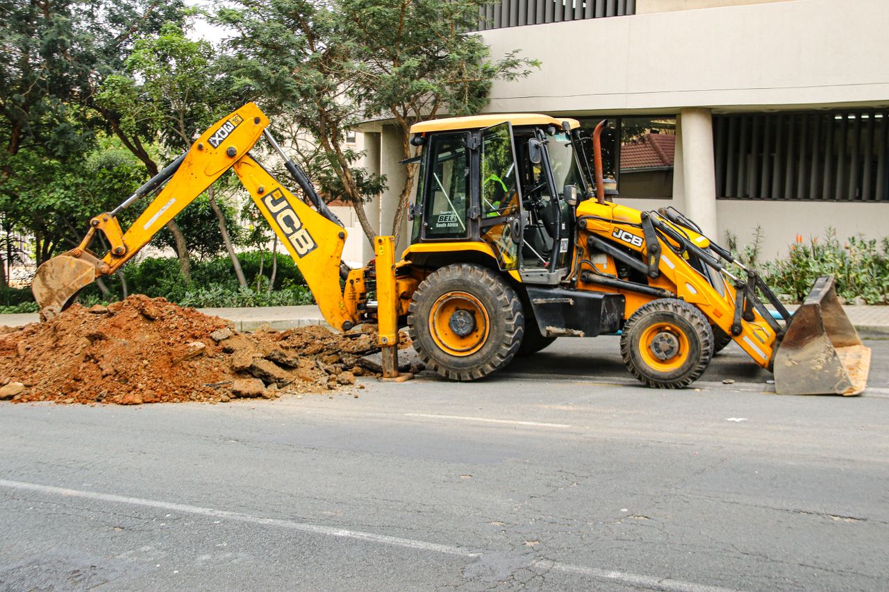 services-03 Street view of an excavator in Sandton, highlighting urban development and construction activities.